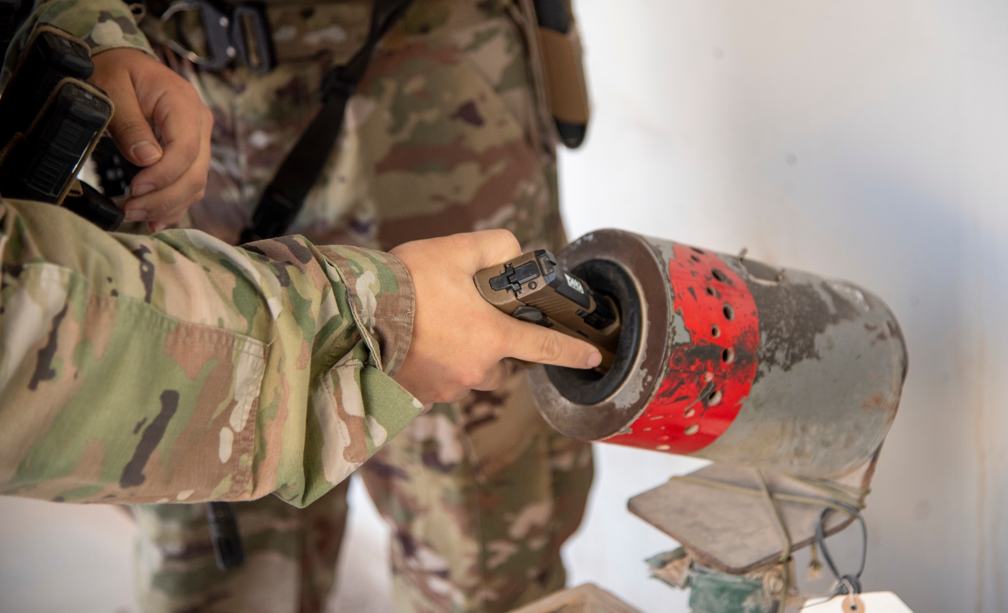 A member of the 332d Expeditionary Security Forces Squadron performs a clear check on an M18 Modular Handgun System at an undisclosed location, Southwest Asia, Oct. 31, 2022. The 332d ESFS Armory provides all lethal and nonlethal weaponry used by Security Forces in base protection and combat operations. (U.S. Air Force photo by: Tech. Sgt. Jim Bentley)