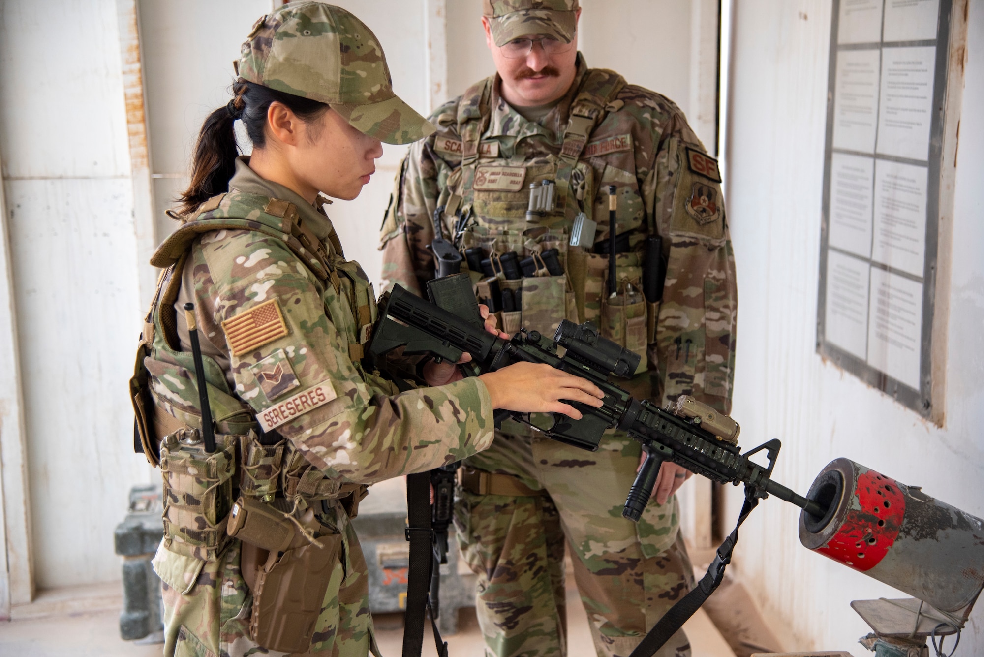 Senior Airman Chamy Sereseres 332d Expeditionary Security Forces Squadron, performs a clear check on an M4A1 carbine at an undisclosed location, Southwest Asia, Oct. 31, 2022. The 332d ESFS Armory provides all lethal and nonlethal weaponry used by Security Forces in base protection and combat operations. (U.S. Air Force photo by: Tech. Sgt. Jim Bentley)