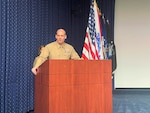 Marine addressed crowd at a podium.