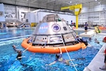 Navy divers, Air Force pararescuemen and Coast Guard rescue swimmers practice Orion recovery techniques at the Neutral Buoyancy Laboratory (NBL) at the agency’s Johnson Space Center in Houston on Sept. 21, 2016. The recovery team is practicing underway recovery techniques using a test version of the Orion spacecraft that was built by Naval Surface Warfare Center, Carderock Division. The Ground Systems Development and Operations Program, along with the U.S. Navy and Lockheed Martin, are preparing the recovery team, hardware and operations to support EM-1 recovery. (NASA photo by James Blair)