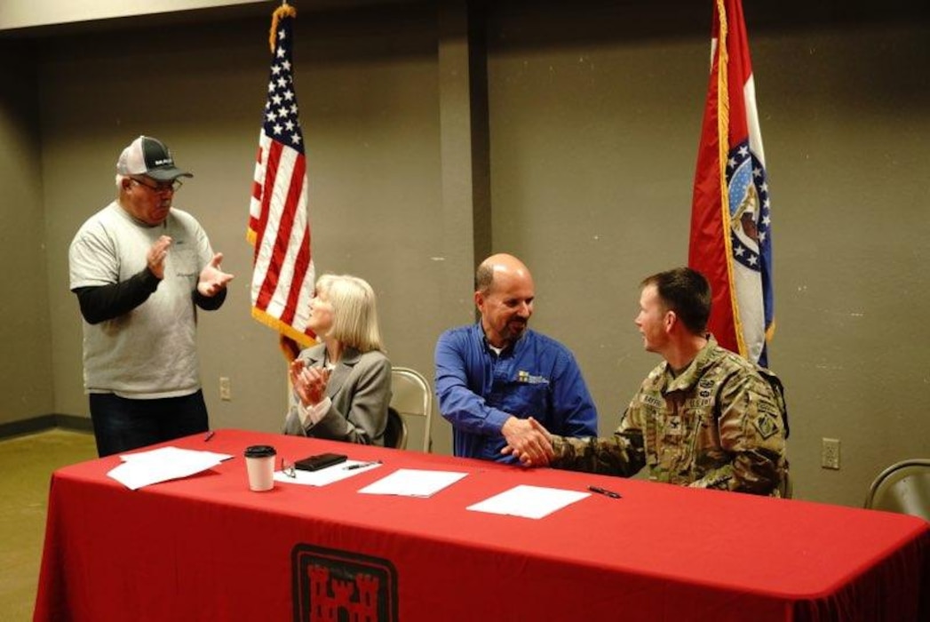 Dru Buntin (right middle), Missouri Department of Natural Resources director, and Col. Travis Rayfield (right), U.S. Army Corps of Engineers, Kansas City District commander, shake hands after signing a Feasibility Cost Share Agreement for a feasibility study in Holt County on Nov. 15, 2022, in Mound City, Missouri. Tom Bullock, Holt County presiding commissioner (left) and Carla Markt, Holt County commissioner 1st District (left middle), were alongside Director Buntin and Col, Rayfield as they signed the study, representing the local area. | Photo by Ben Nickelson, Missouri Department of Natural Resources.