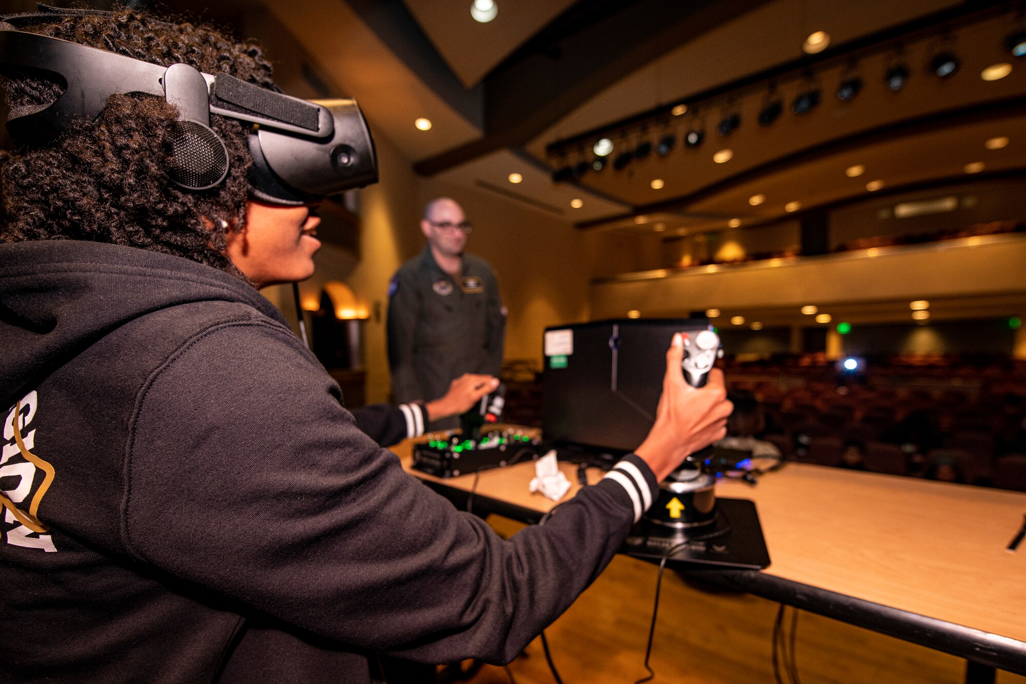 A student from Oak Park High School, Oak Park, Michigan, tests her skill on a flight simulator