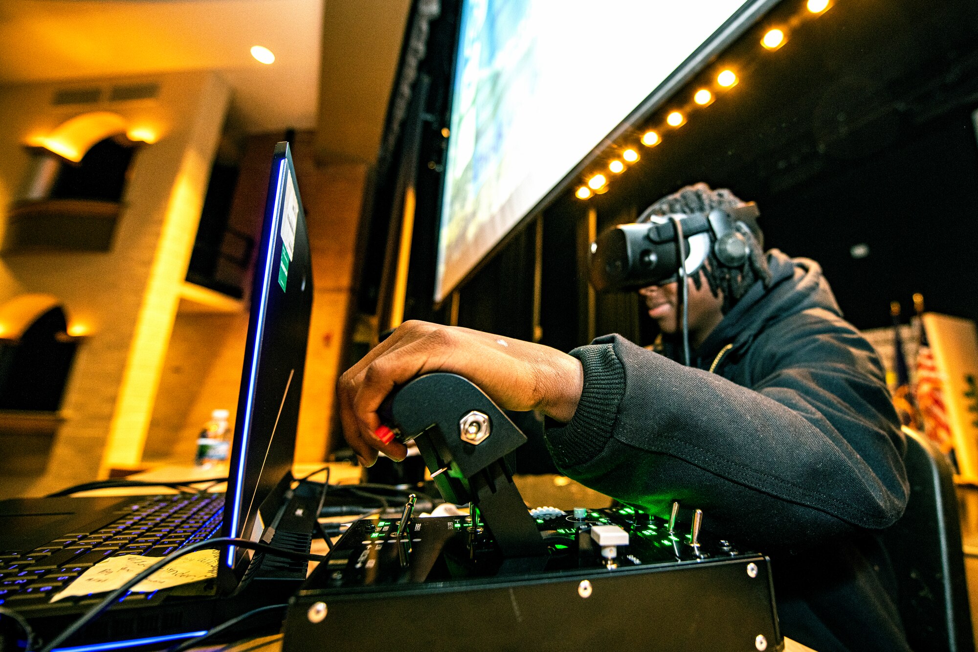 A student from Oak Park High School, Oak Park, Michigan, tests his skill on a flight simulator following a presentation about the Aim High Flight Academy by U.S. Air Force