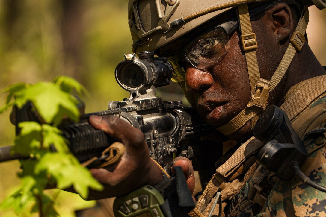 U.S. Marine Lance Cpl. Jayrell Carter, a transmissions system operator with 2d Air Naval Gunfire Liaison Company, II Marine Expeditionary Force Information Group, sets up rear security during simulated force-on-force training event during warfighter week on Camp Lejeune, North Carolina, April 28, 2022. Warfighter week is a week-long training event to ensure familiarity with ground operations and technical proficiency, providing liaison assets to foreign countries across all domains. (U.S. Marine Corps photo by Sgt. Joshua Davis)