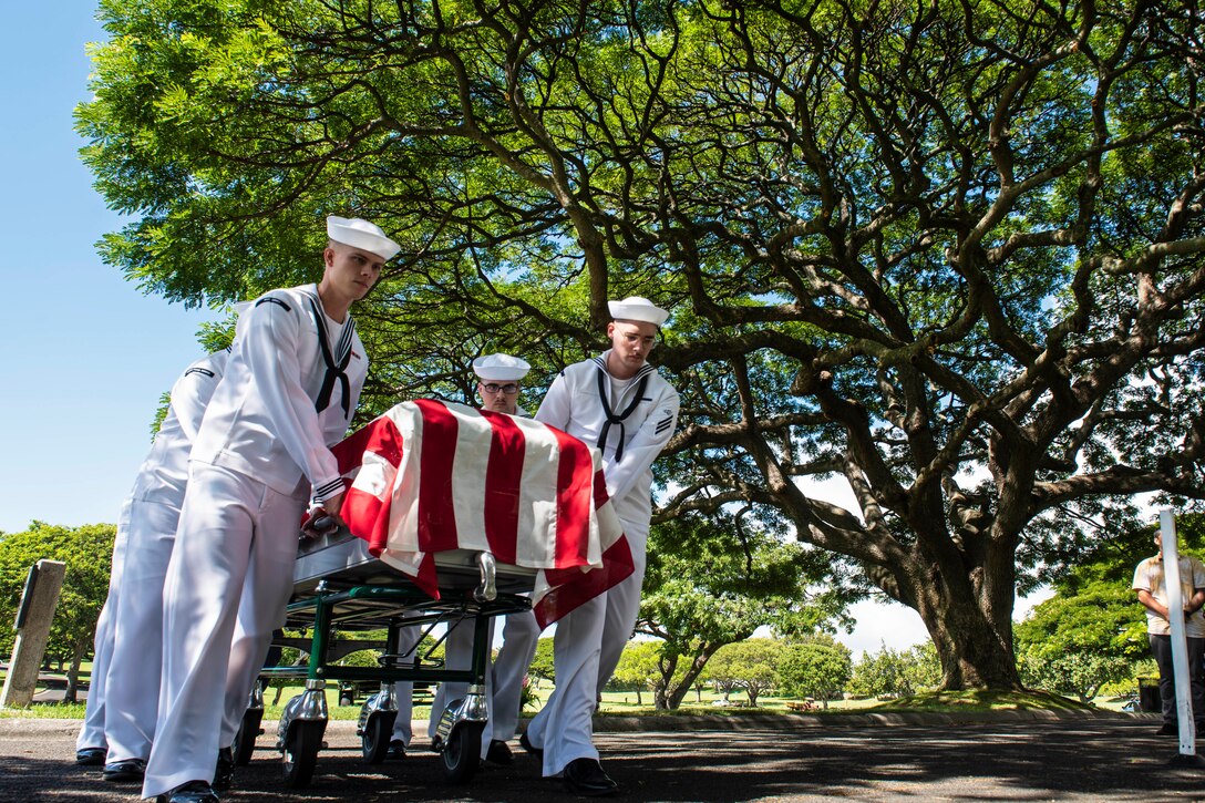 Sailors conduct an interment ceremony.