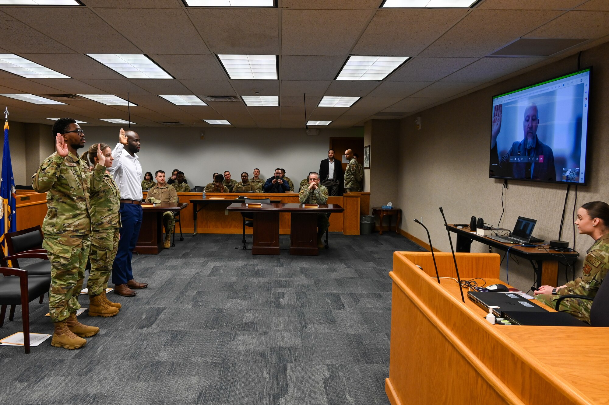 Airman 1st Class Jarious George from the 5th Force Support Squadron, Airman 1st Class Kojo Affainie and Airman Constanza De Puerta, from the 5th Logistics Readiness Squadron, earn their United States citizenship during a naturalization ceremony, Nov. 15, 2022, at Minot Air Force Base, North Dakota. During the ceremony, the Airmen were presented with their Certificates of Naturalization, making them U.S. citizens by law. (U.S. Air Force photo by Senior Airman Zachary Wright)