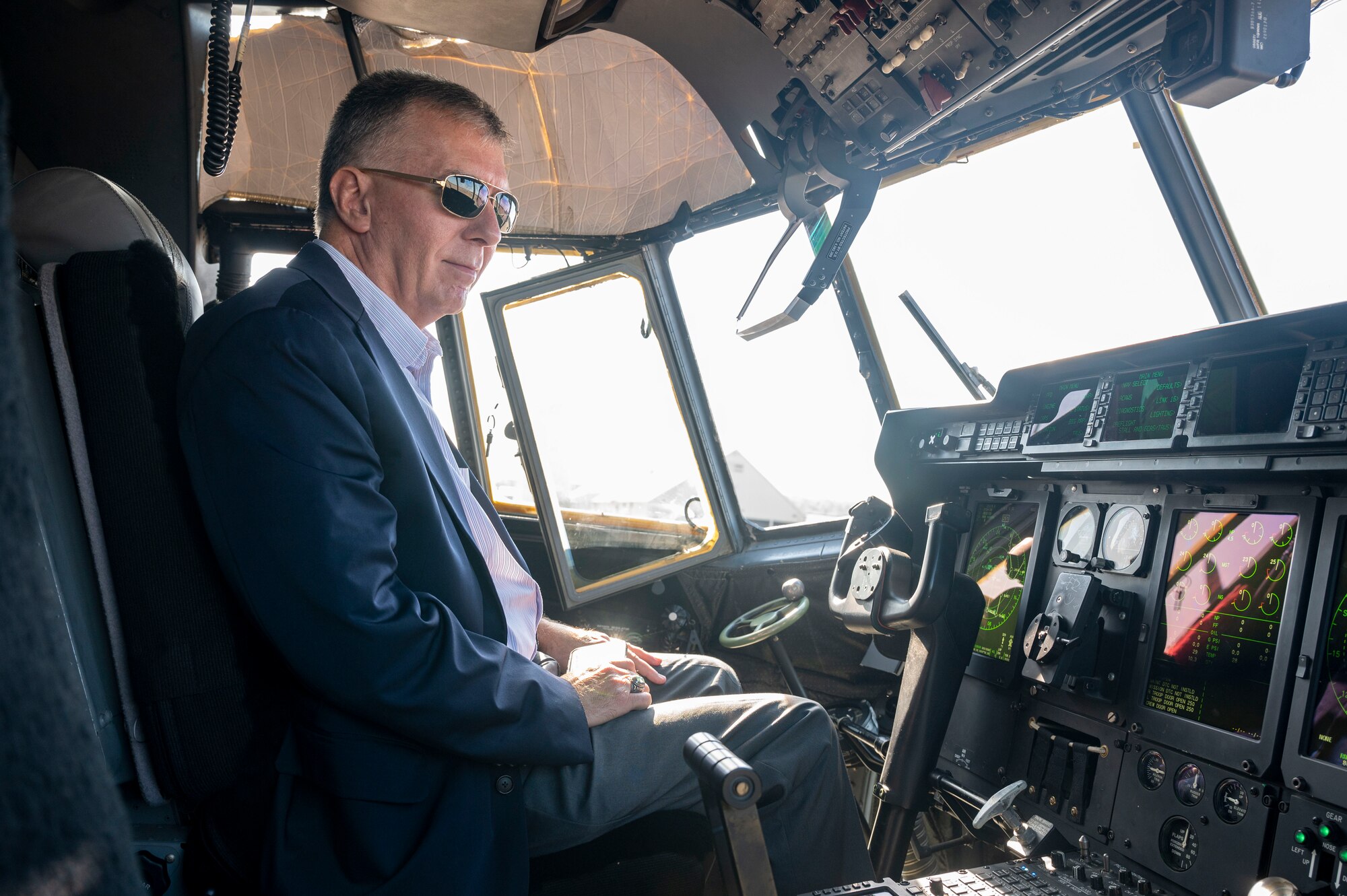 A man sits in the cockpit of an aircraft