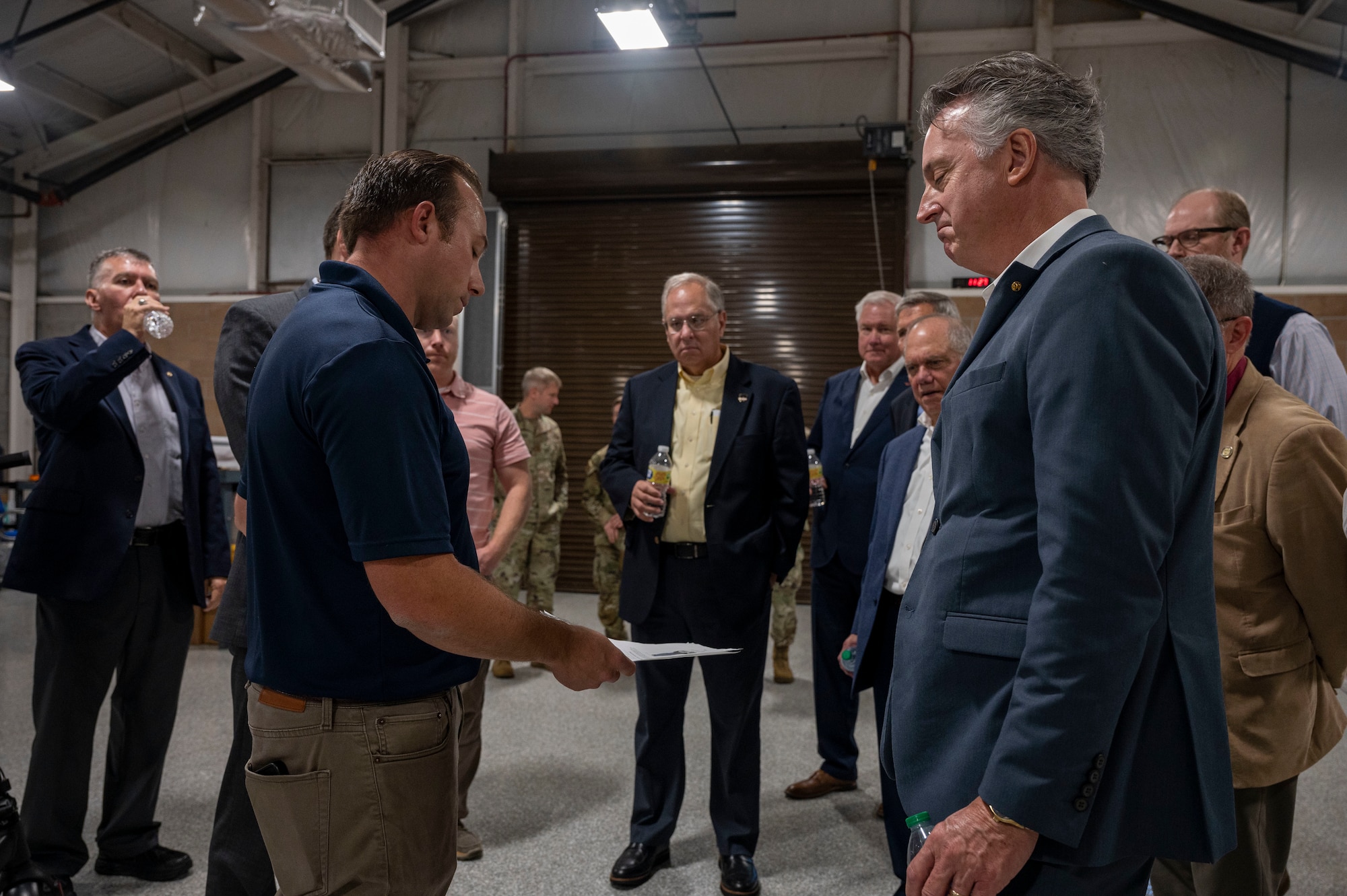 a group of men talk with each other