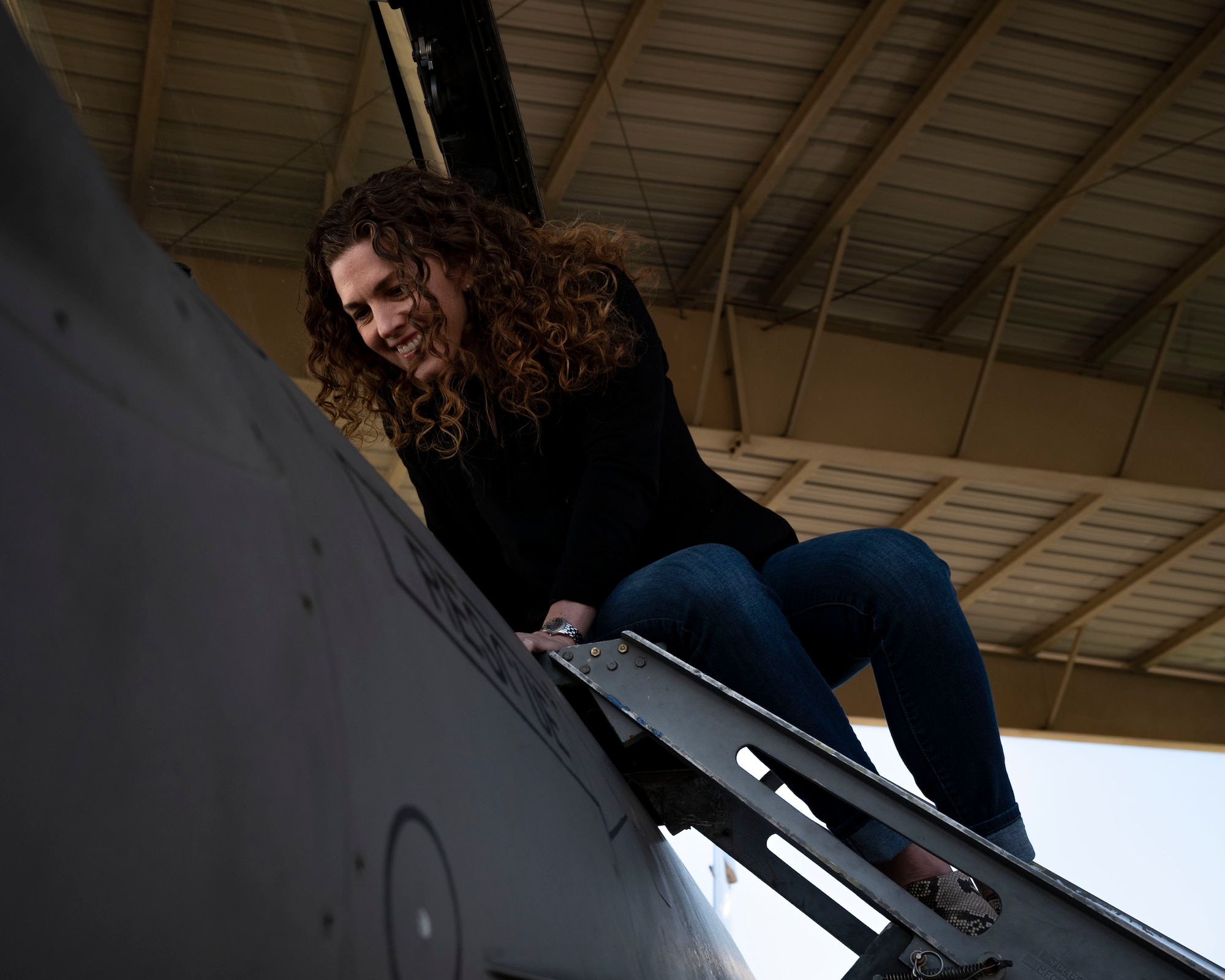 Donna Weller looks into cockpit of F-16C Fighting Falcon