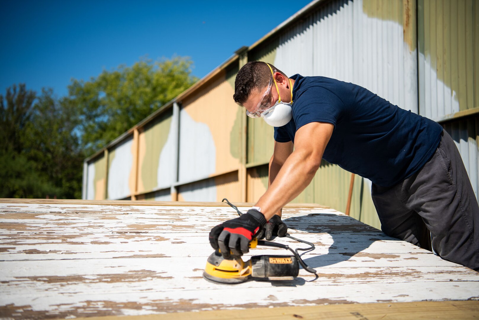 Man is sanding wood