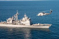 NAVAL AIR FACILITY ATSUGI, Japan (Nov. 16, 2022) An MH-60R Sea Hawk helicopter assigned to the "Warlords" of Helicopter Maritime Strike Squadron FIVE ONE (HSM 51) attached to Naval Air Facility (NAF) Atsugi, conducts passes the Guided-Missle Cruiser USS Shiloh (CG 67) during a flight exercise.