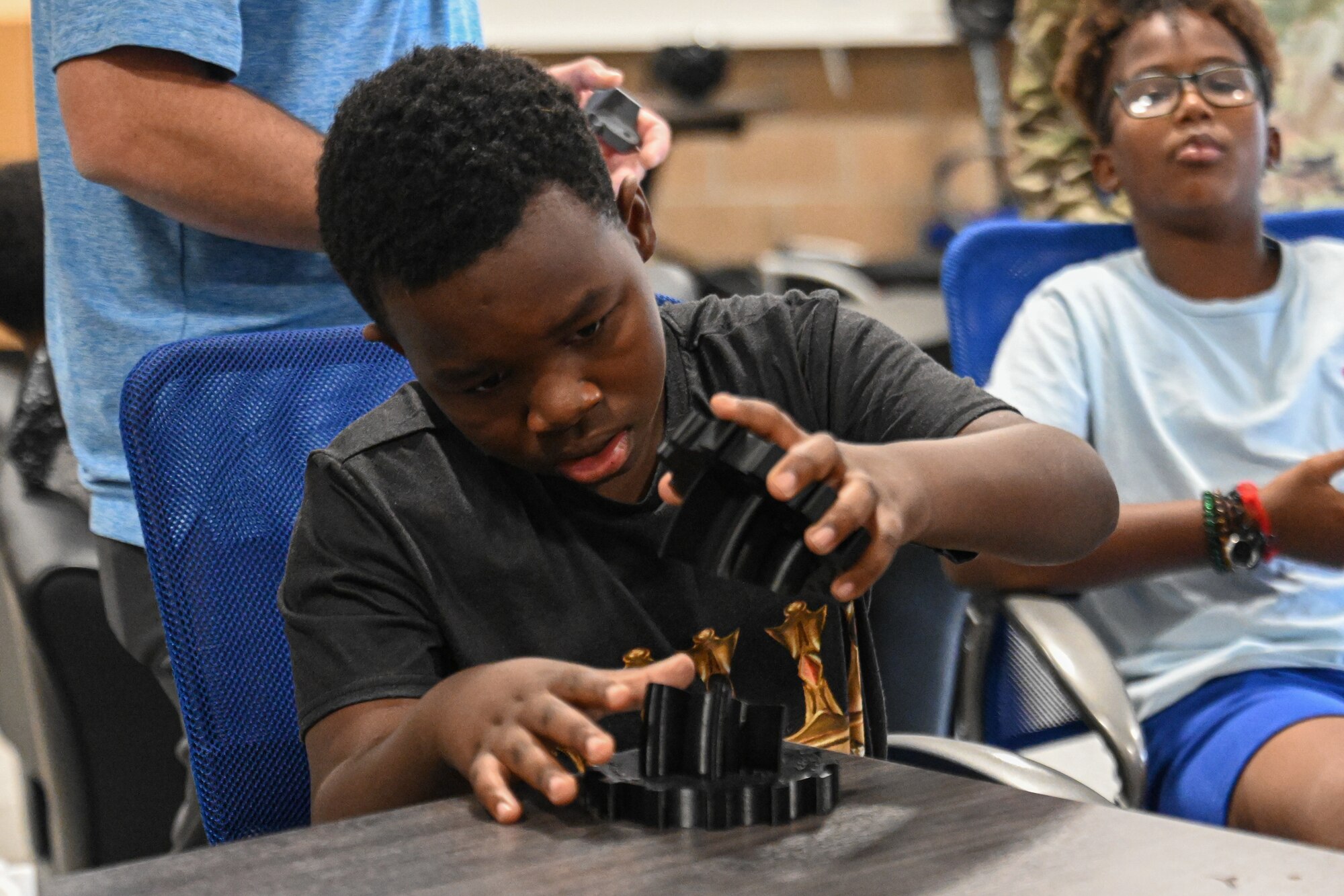 A child puts plastic objects together.