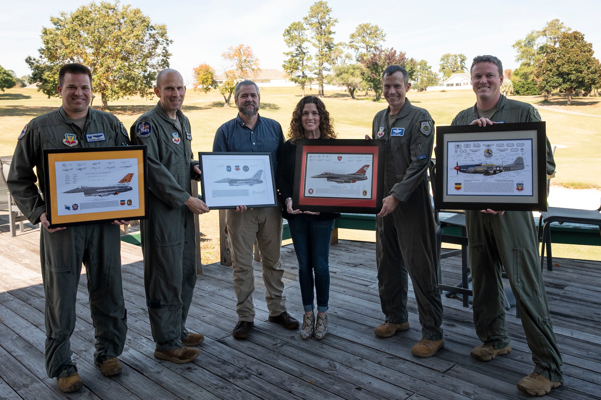 20th Fighter Wing leadership present signed lithographs to FAA representatives.