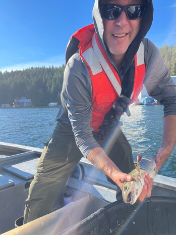 Navy fish biologist Paul Rudell holds a bull trout