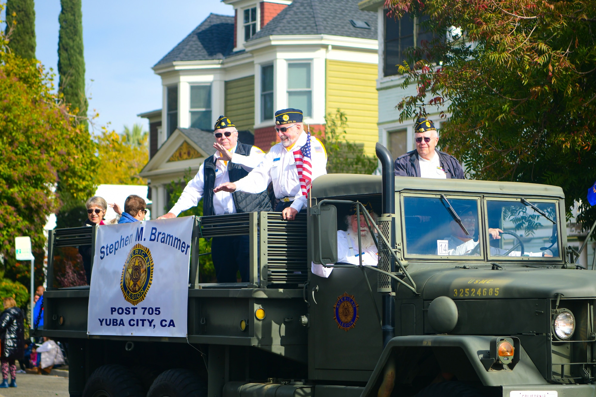 Participants in the parade wave to the crowd during the Veterans Day parade in Marysville, Calif., on Nov. 11, 2022.