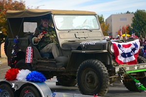 Participants in a parade wave to the onlookers during a Veterans Day parade in Marysville, Calif., on Nov. 11, 2022.