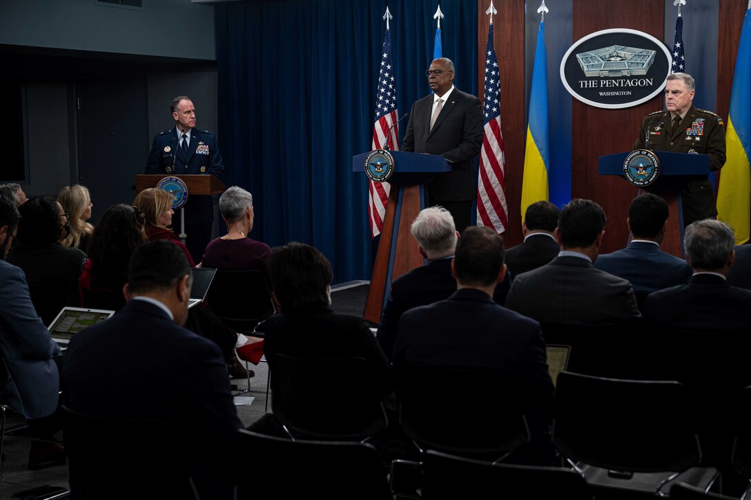 Secretary of Defense Lloyd J. Austin III and Chairman of the Joint Chiefs of Staff U.S. Army Gen. Mark A. Milley stand at a podium in front of reporters.