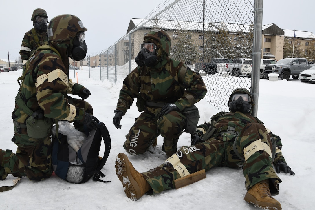 Staff Sgt. Charity Sisco and Airman 1st Class Alyssa Longley of the 168th Medical Group respond and provide care to injured Airmen while wearing chem gear and part of a post-attack reconnaissance team during the Golden Raven 23-1 exercise at Eielson Air Force Base, Alaska. Team Eielson exercised the capability to accomplish the mission while countering CBRN threats. (U.S. Air National Guard photo by Senior Master Sgt. Julie Avey)