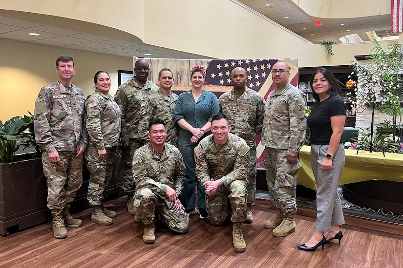 Military and civilian personnel from the 85th U.S. Army Reserve Support Command pause for a photo with Holly Campa, Church Creek Senior Assisted Living Center staff member, during their Veteran’s luncheon, November 9, 2022, in Arlington Heights, Illinois.