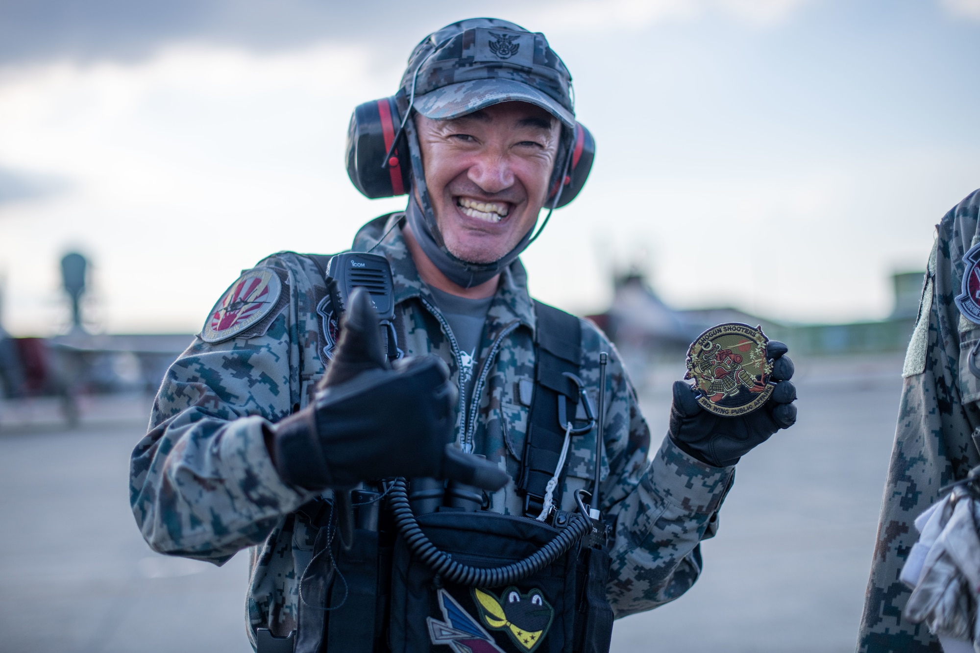 A Japanese military crew chief holds a patch.