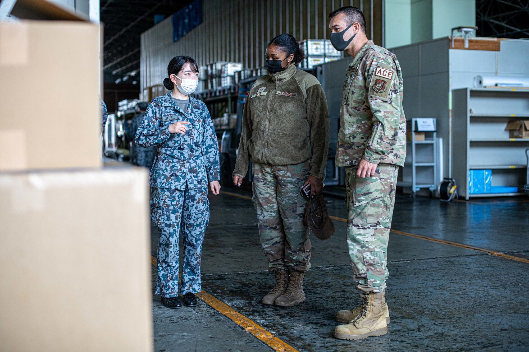 A Japanese military member gives a tour to Airmen.