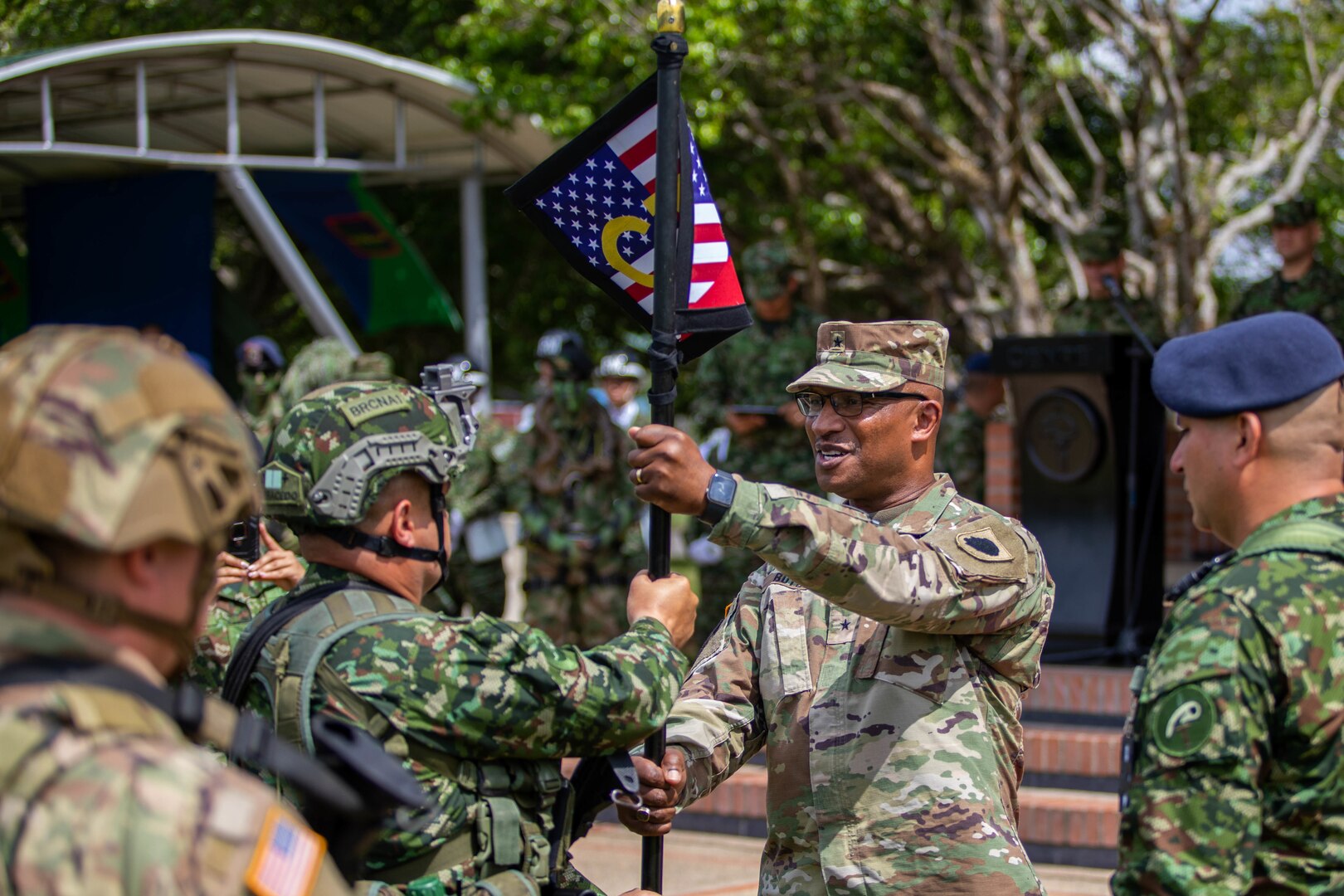 Brig. Gen. Rodney Boyd, Assistant Adjutant General – Army and Commander of the Illinois Army National Guard, passes the Combined Task Force (CTF) guidon to the CTF commander during the opening ceremony of Exercise Southern Vanguard 23 on Nov. 8 at Tolemaida Military Base, Colombia.