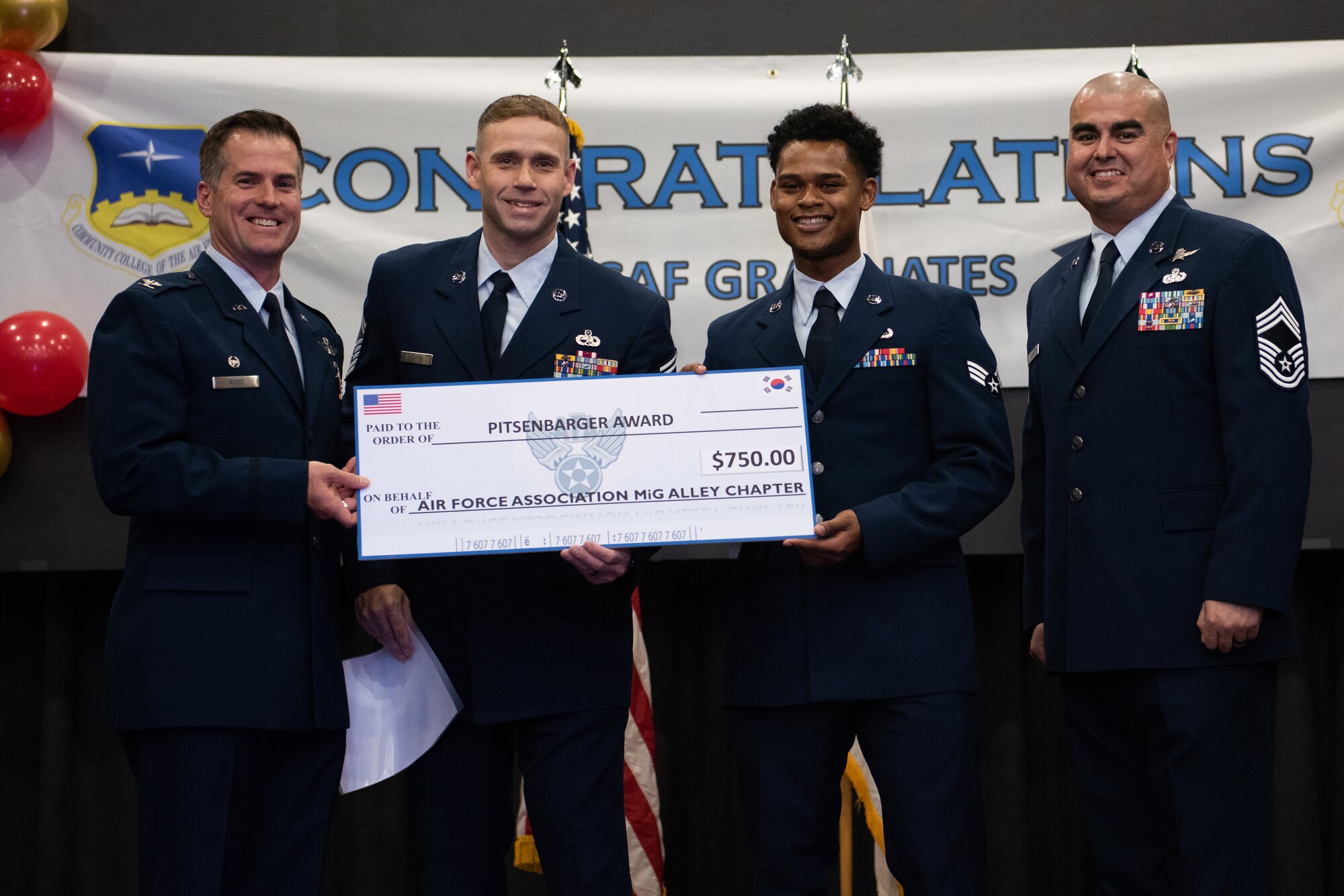 U.S. Air Force Senior Airman Casa Abraham Stuckey, 607th Materiel Maintenance Squadron client systems technician, is awarded the Pitsenbarger Award during a Community College of the Air Force graduation ceremony at Osan Air Base, Republic of Korea, Nov. 15, 2022.