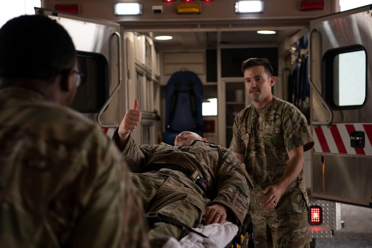 U.S. Air Force Capt. Taylor Soster, 386th Expeditionary Logistics Readiness Squadron aerial port flight commander, is moved into an ambulance during a First Responder Day demonstration at Ali Al Salem Air Base, Kuwait, Nov. 11, 2022. The medical demonstration was one of five during the Company Grade Officer Council’s First Responder Day tour around Ali Al Salem Air Base. (U.S. Air Force photo by Staff Sgt. Ashley N. Mikaio)