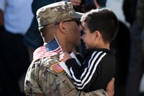Staff Sgt. Robert Chavez, a signal support systems specialist with the 3631st Signal Company, reunites with his children at the Rio Rancho Readiness Center Nov. 15, 2022, following a 10-month deployment to the Central Command Area of Responsibility to support Operation Spartan Shield. The unit provided communications support to forces across the region.