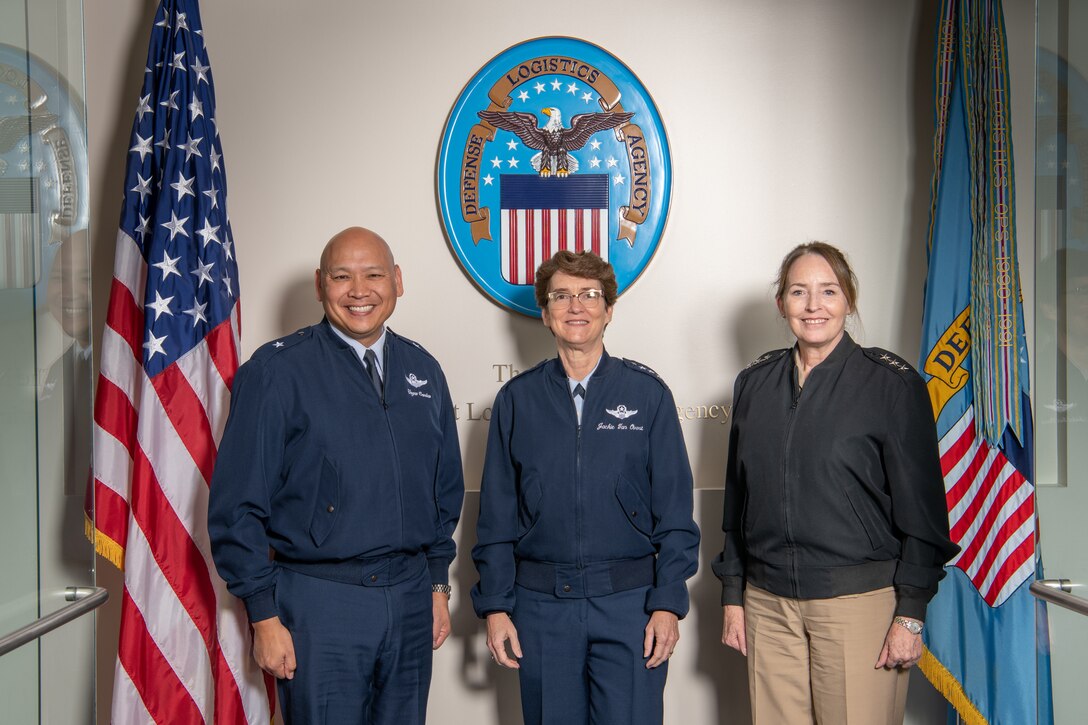 Three military personnel pose for a group photo