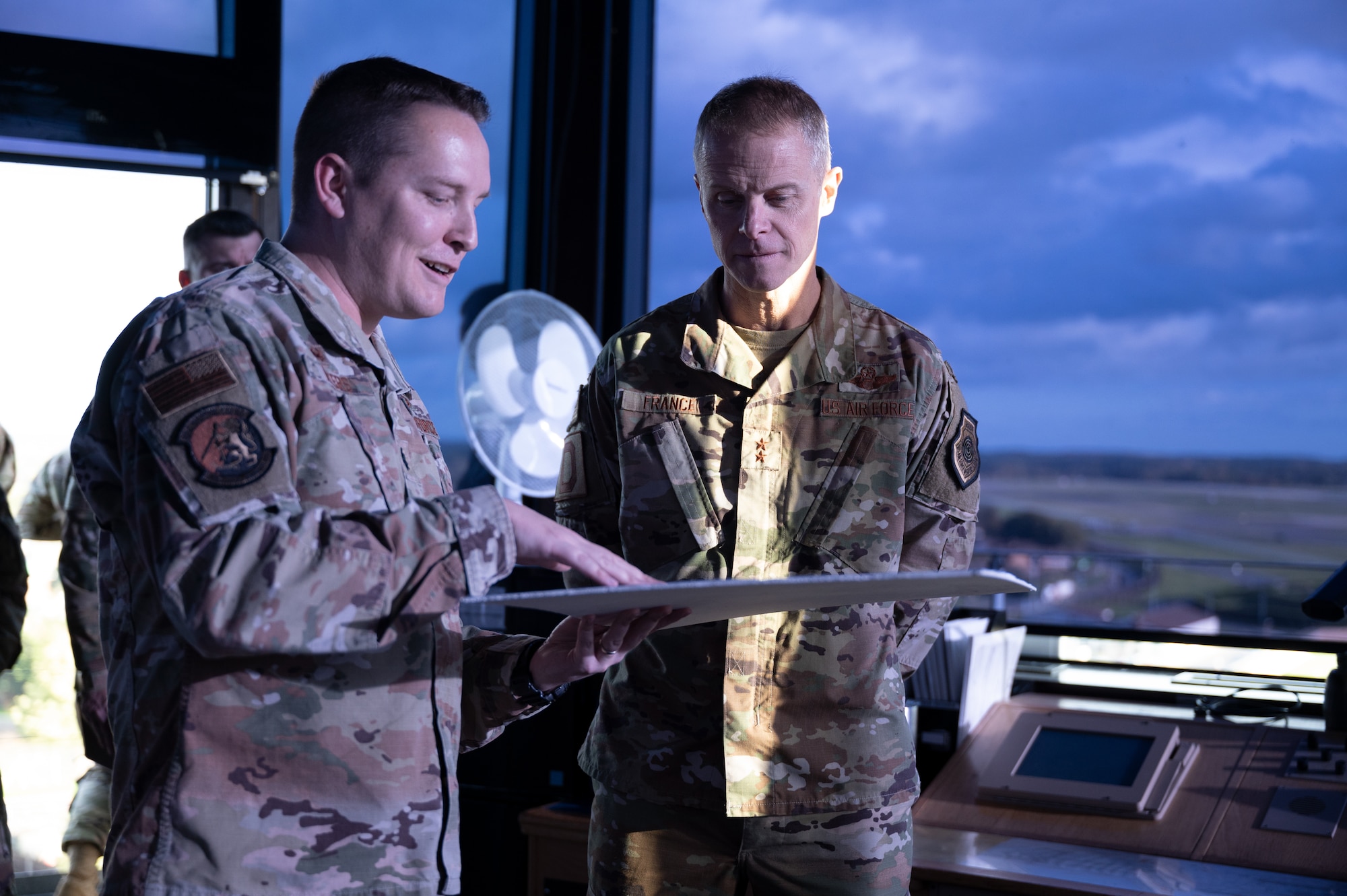 U.S. Air Force Maj. Gen. Derek France, Third Air Force commander, speaks with Lt. Co. Joshua Evans, 100th Operations Support Squadron commander, during his visit to Royal Air Force Mildenhall, England, Nov. 11, 2022. France traveled to Mildenhall to meet with Airmen, learn about their skills, and observe how they support 3rd AF, U.S. Air Forces in Europe and Air Forces Africa, and U.S. European Command. (U.S. Air Force photo by Airman 1st Class Viviam Chiu)