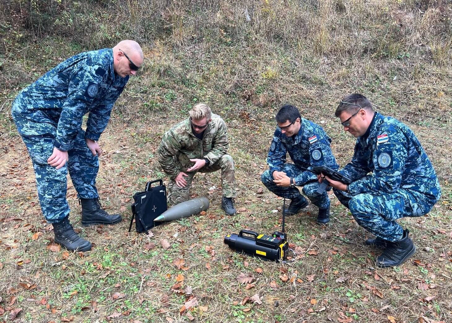 Explosive Ordnance Disposal 2nd Class Jerimiah Maat, second from left, assigned to Carrier Strike Group (CSG) 10, and Croatian explosive ordnance disposal personnel x-ray a 155mm projectile during the practical instruction portion of a U.S. State Department humanitarian mine action initiative, Nov. 9, 2022. The George H.W. Bush CSG is on a scheduled deployment in the U.S. Naval Forces Europe area of operations, employed by U.S. Sixth Fleet to defend U.S., allied, and partner interests.