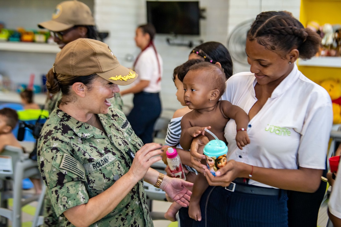 Cmdr. Angela Roldan-Whitaker, from Bogota, Colombia, plays with a child during a Continuing Promise 2022 event in Cartagena, Colombia.
