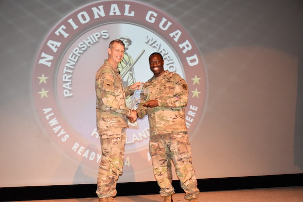 JFSC Commandant Brigadier General Voris McBurnette presents General Hokanson with a plaque during his induction into NDU Hall of Fame.