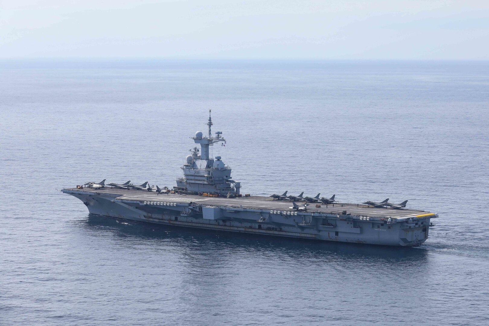 The French aircraft carrier Charles de Gaulle (R 91) transits the Mediterranean Sea while underway with Arleigh Burke-class guided-missile destroyer USS Ross (DDG 71), March 17.