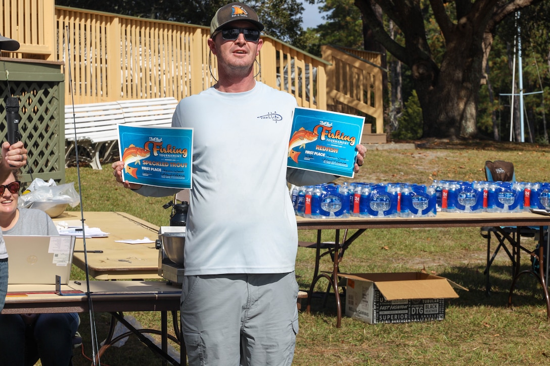 Kevin Wood, winner of both the speckled trout and redfish competition categories, displays his certificates after completing the "Get Reel About Prevention" fishing tournament, Hancock Marina, Marine Corps Air Station (MCAS) Cherry Point, North Carolina, Nov. 4, 2022. The tournament allowed U.S. Marines, their families, and air station civilians the opportunity to gather for a fun, collective competition and learn more about various violence prevention resources. (U.S. Marine Corps photos by Lance Cpl. Tristen Reed)
