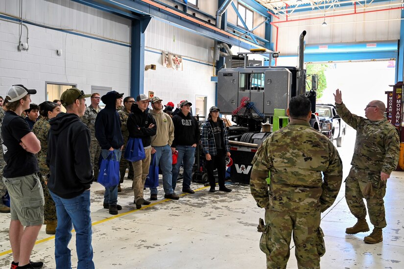 Members of the 201st Rapid Engineer Deployable, Heavy Operational Repair Squadron Engineer (RED HORSE), Detachment 1 host a tour of their vehicle maintenance facility for local high school juniors and seniors during a military career fair Nov. 9, 2022. Brandon Roach, top right, a senior at Garnet Valley High School, was one of 70 students from approximately eight local high schools who attended the event for an opportunity to learn more about Pennsylvania Air National Guard careers from dozens of men and women currently serving with the 111th Attack Wing at Biddle Air National Guard Base in Horsham, Pennsylvania.