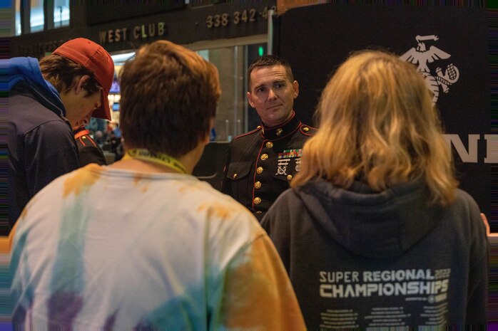 U.S Marine Corps Staff Sgt. Byron Reed, 9th Marine Corps Recruiting District musician technical assistant, speaks with students at the Bands of America Grand National Championship on Lucas Oil Stadium, Indianapolis, Ind., Nov. 11, 2022. Marine Corps Recruiting Command is proud to partner with Music for All, this partnership helps increase awareness of the Marine Corps’ opportunities and connect with band directors, influencers and students.