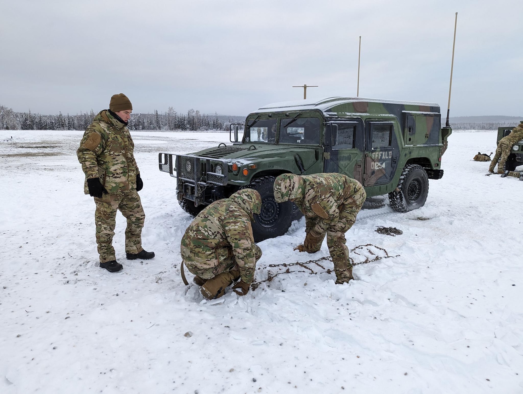 Airmen prepare tire chains for vehicle