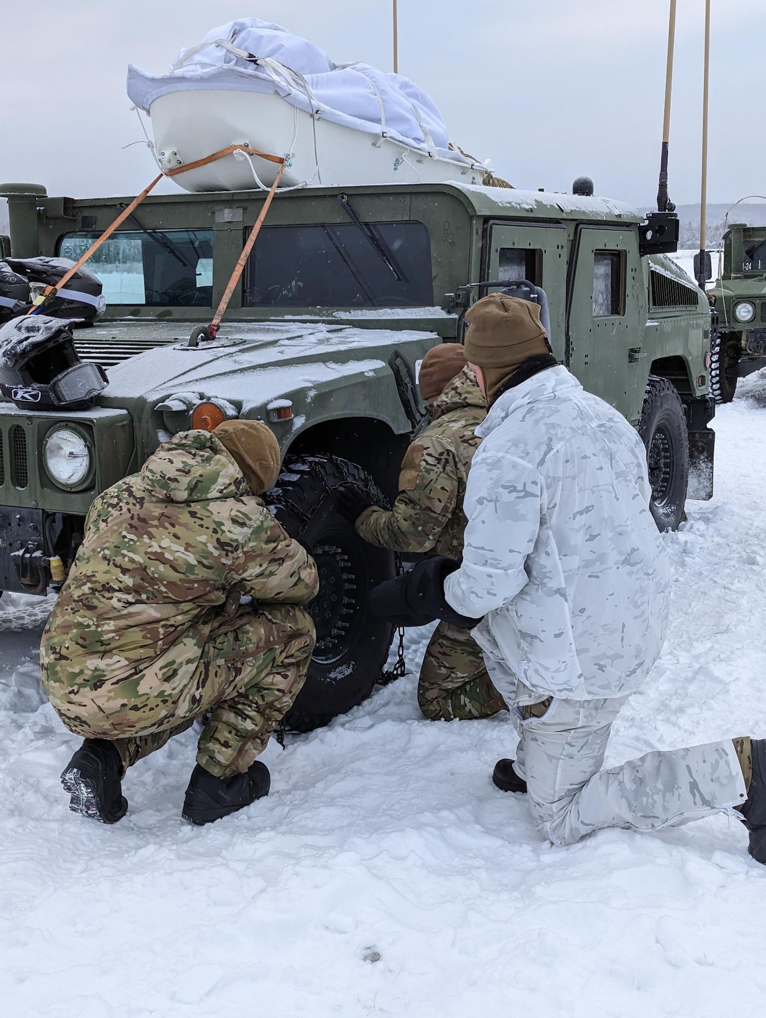 Airmen place chains on tire