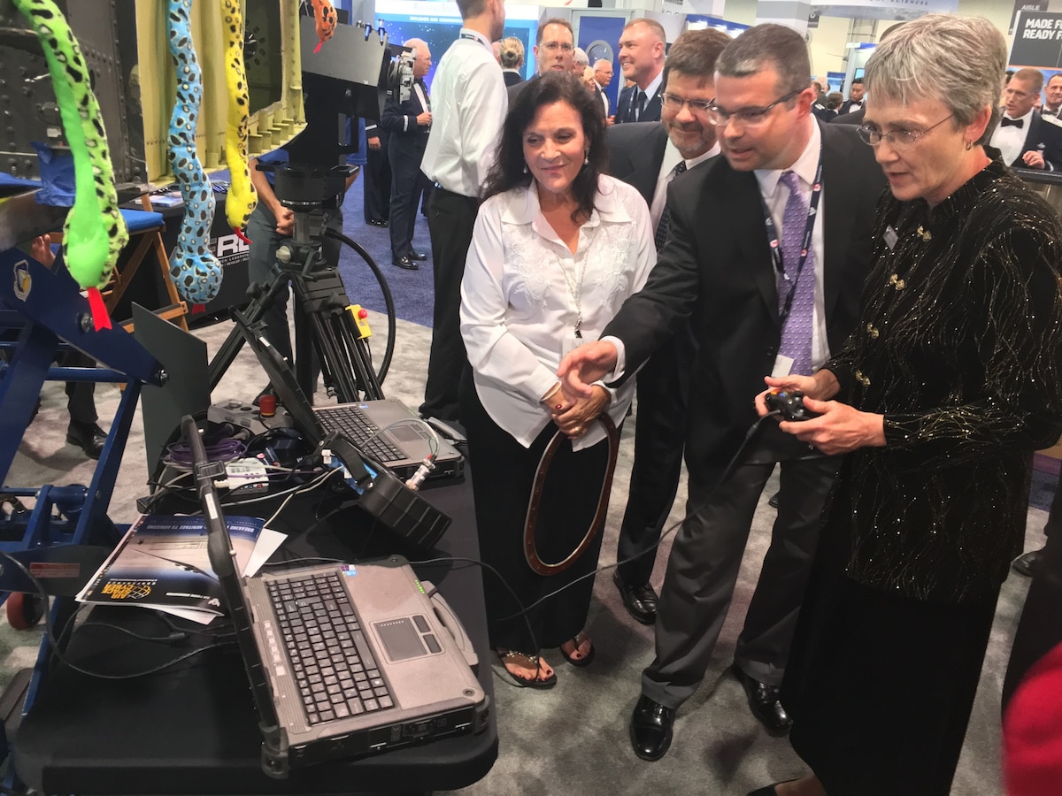 Lenell Kern, the lead for Strategic Engagements at the Air Force Research Laboratory, far left, presents AFRL technology to former Secretary of the Air Force Heather Wilson, far right, during the Air Force Association’s Air, Space and Cyber Conference in National Harbor, Maryland, Sept. 17, 2018. Charles Buynak from AFRL’s Materials and Manufacturing Directorate and Sean Coghlan from Air Force Materiel Command, center, view the technology. (U.S. Air Force photo / Michele Miller)