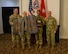 men and women wearing u.s. army uniforms standing in front of flags.