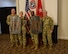 men and women wearing u.s. army uniforms standing in front of flags.