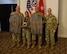 men and women wearing u.s. army uniforms standing in front of flags.