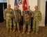 men and women wearing u.s. army uniforms standing in front of flags.