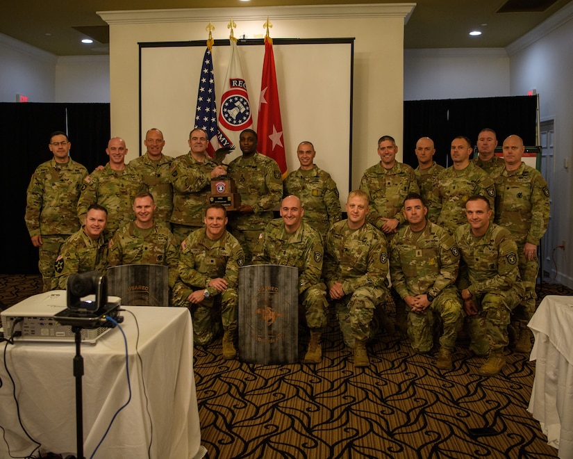 men and women wearing u.s. army uniforms standing in front of flags.