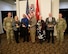 men and women wearing u.s. army uniforms standing in front of flags.