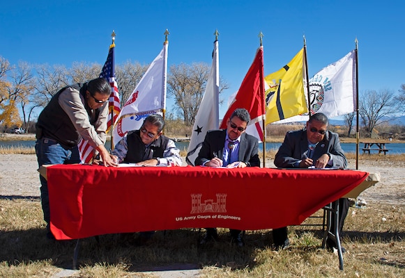 Ohkay Owingeh Councilman Ron Lovato (standing) assists Gov. J. Patrick Aguino in signing, along with the ASA(CW) Michael Connor and Santa Clara Pueblo Gov. J. Michael Chavarria (far right), the official design agreements for the Espanola Valley Ecosystem Restoration project, Nov. 9, 2022.