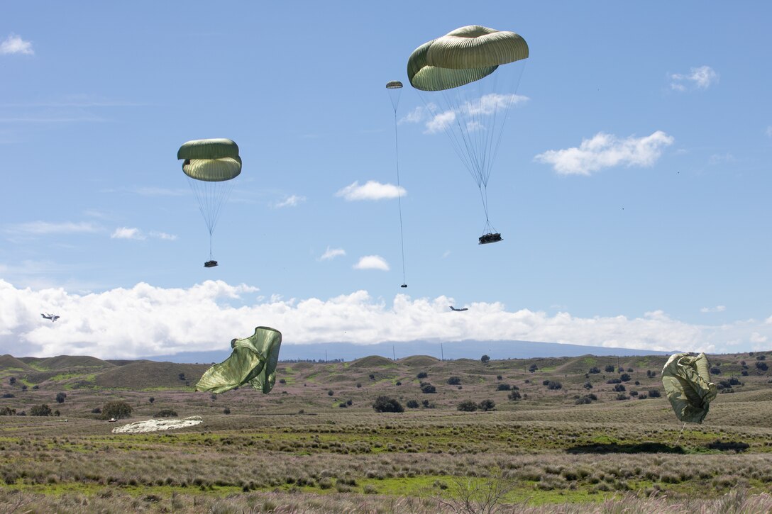 U.S. Air Force C-130s conduct an airdrop on Pohakuloa Training Grounds, Hawaii, Nov 1, 2022. Joint Pacific Multinational Readiness Center 23-01 is a regional combat training center (CTC) rotation that builds combat readiness in Americas Pacific Division and is a key way the Army forces engage in a joint environment with our regional allies and partners. (U.S. Army photo by Pfc. Wyatt Moore / 28th Public Affairs Detachment)