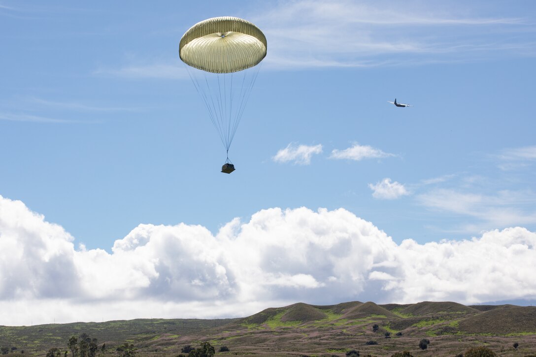 U.S. Air Force C-130s conduct an airdrop on Pohakuloa Training Grounds, Hawaii, Nov 1, 2022. Joint Pacific Multinational Readiness Center 23-01 is a regional combat training center (CTC) rotation that builds combat readiness in Americas Pacific Division and is a key way the Army forces engage in a joint environment with our regional allies and partners. (U.S. Army photo by Pfc. Wyatt Moore / 28th Public Affairs Detachment)
